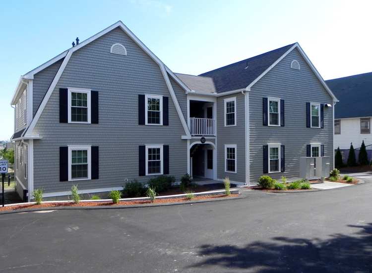 Exterior view of the apartment community with parking space at Coddington Point in Newport, Rhode Island