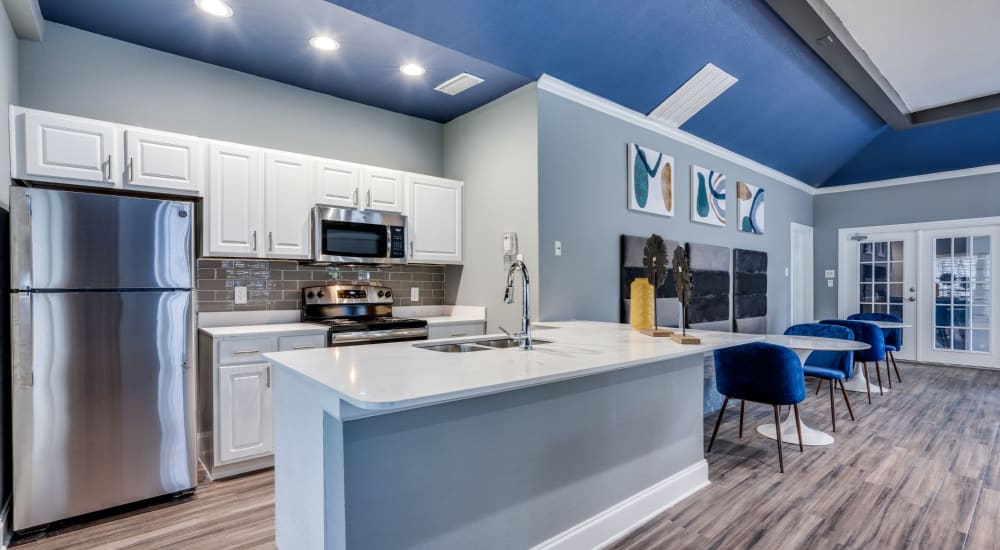 Modern kitchen with wood-style flooring at The Reese at Eastchase in Fort Worth, Texas 