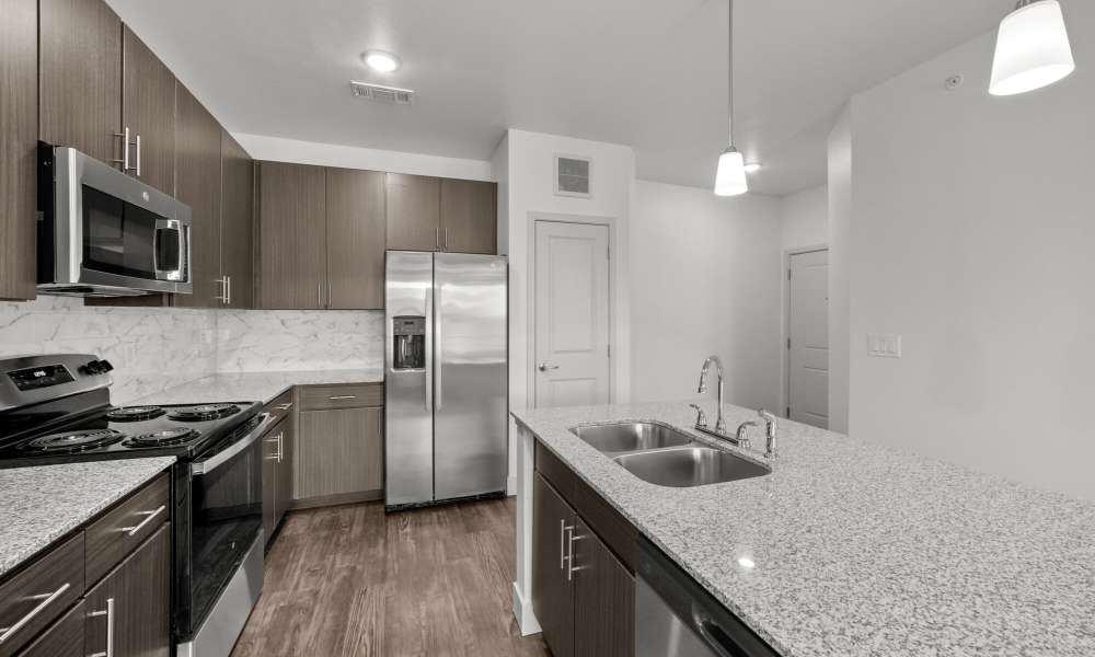 Open kitchen with wood flooring at Brook Hollow in Wichita Falls, Texas