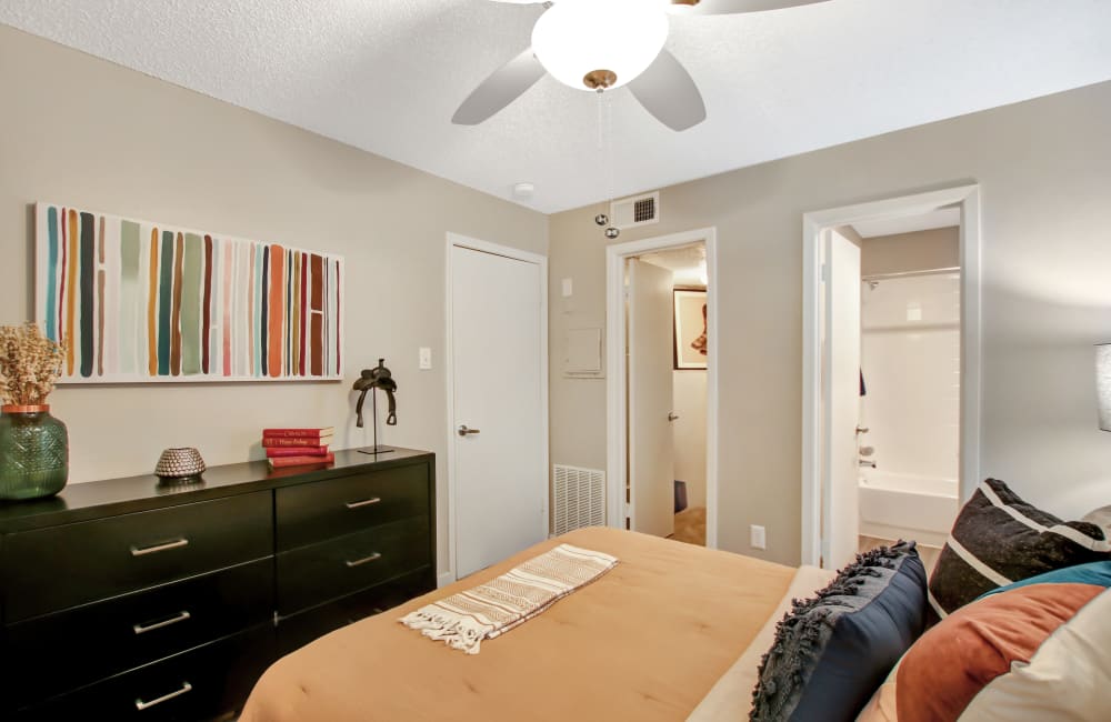 Comfortable queen sized bed in a bedroom at Lockhart Apartment Homes in Mesquite, Texas