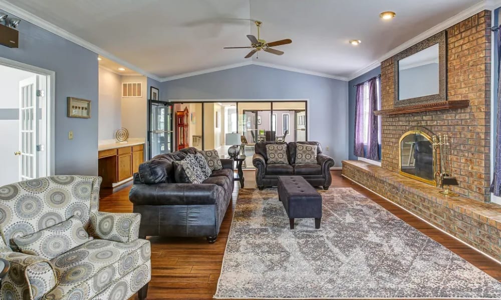 Community gathering space with a large fireplace at Burlington Oaks in Burlington, Kentucky