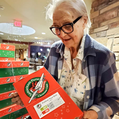 Resident holding a gift box at The Oxford Grand Assisted Living & Memory Care in Wichita, Kansas