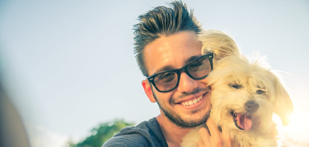 Resident holding his puppy at Casa Vera in Miami