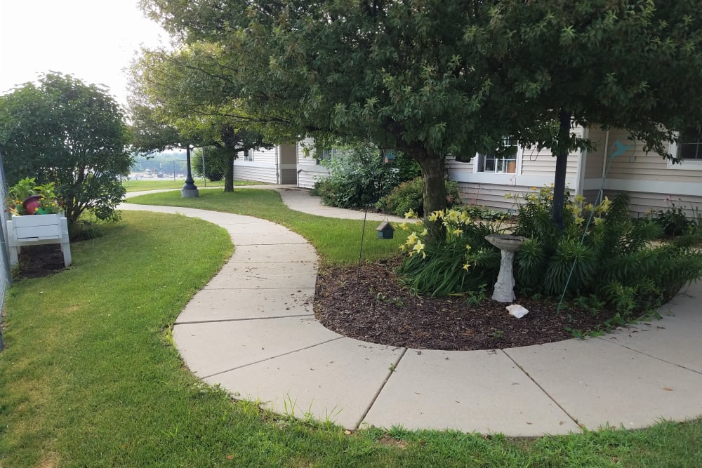 Walking path through lush landscaping at Clover Ridge Place in Maquoketa, Iowa.