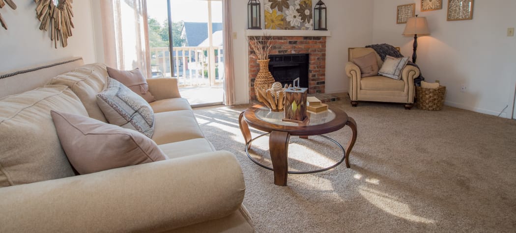 Spacious living room with a fireplace at The Mark Apartments in Ridgeland, Mississippi