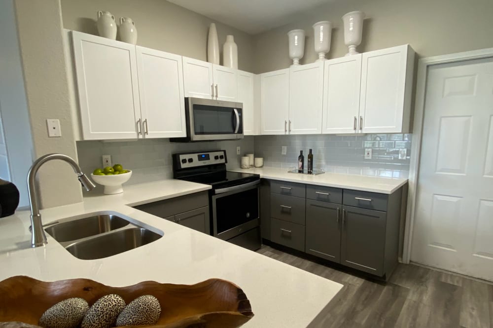 Gourmet kitchen with stainless steel appliances at Montrachet Apartment Homes in Lakewood, Colorado