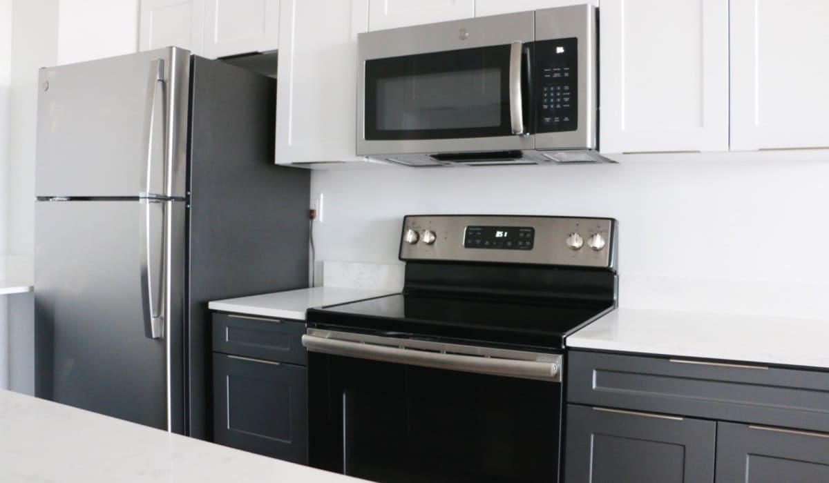 Cozy and bright kitchen with stainless-steel appliances at 1900 Ocean Apartment Homes in Long Beach, California