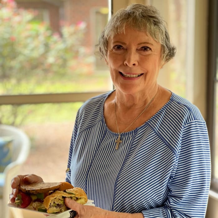 Resident holding a plate of food at The Foothills Retirement Community in Easley, South Carolina