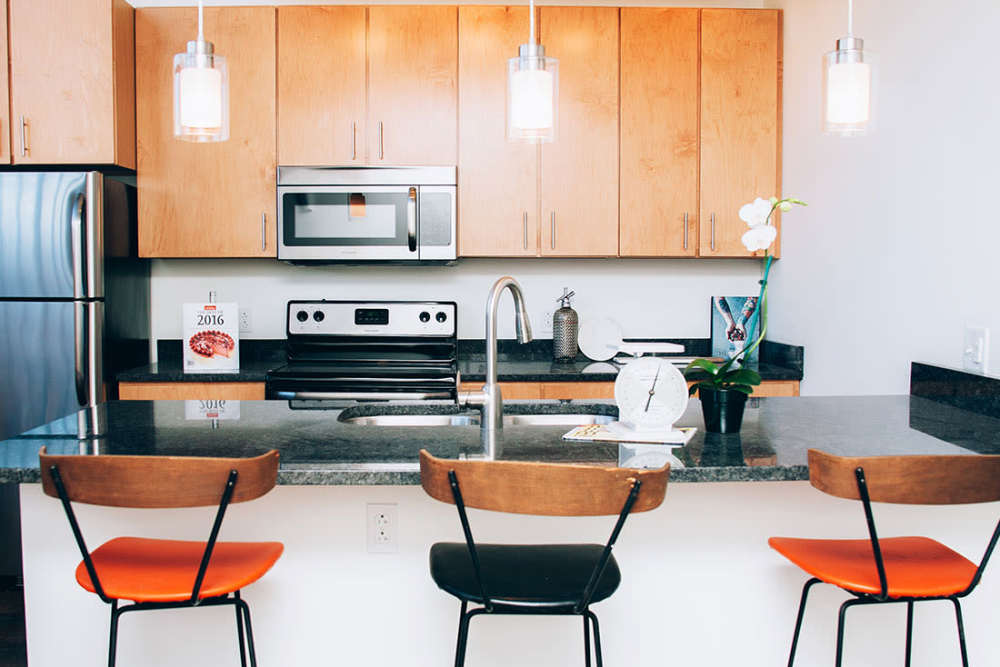 Modern kitchen with stainless steel appliances at Courtyard Lofts at Scott’s Addition in Richmond, Virginia