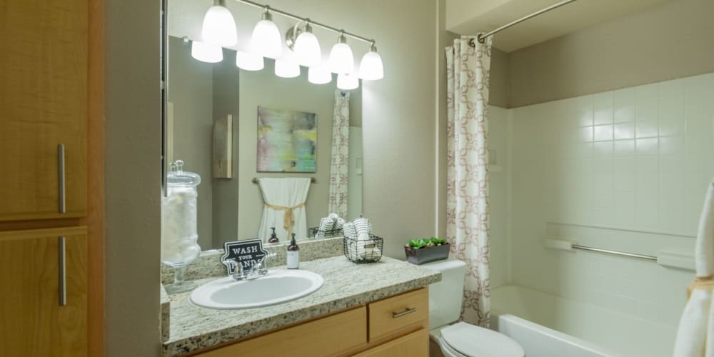 Brightly-lit modern bathroom at  Pinnacle at Galleria Apartments in Roseville, California