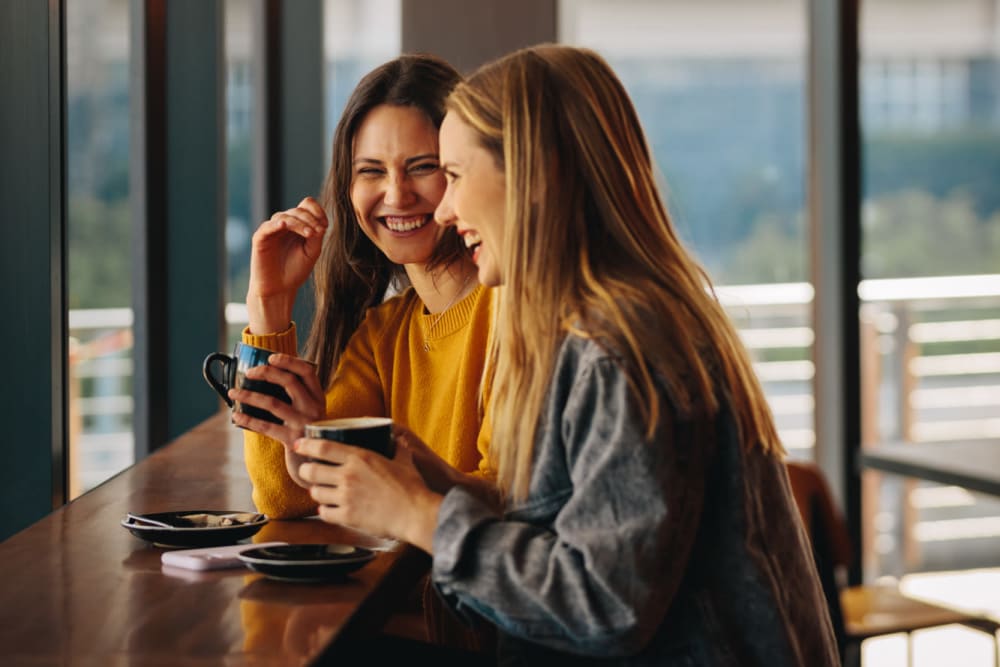 Residents catching up over coffee at a cafe near New Barn Apartments in Miami Lakes, Florida