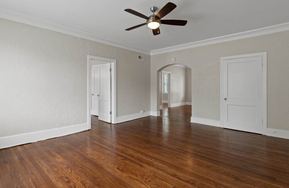 Unfurnished living room with wooden flooring at The Avalon in Memphis, Tennessee