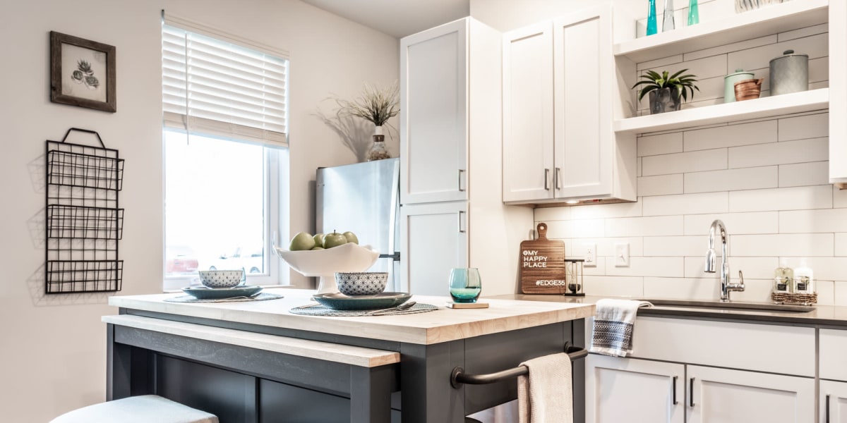 Kitchen with white cabinets at Nolan Living in Leawood, Kansas