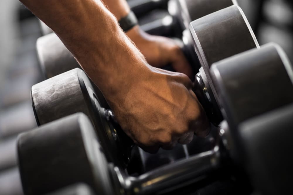 Resident holding free weights at Chesterfield Flats, North Chesterfield, Virginia