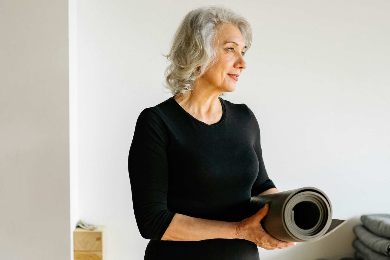 Resident with yoga mat at RIVA Solana Beach in Solana Beach, California