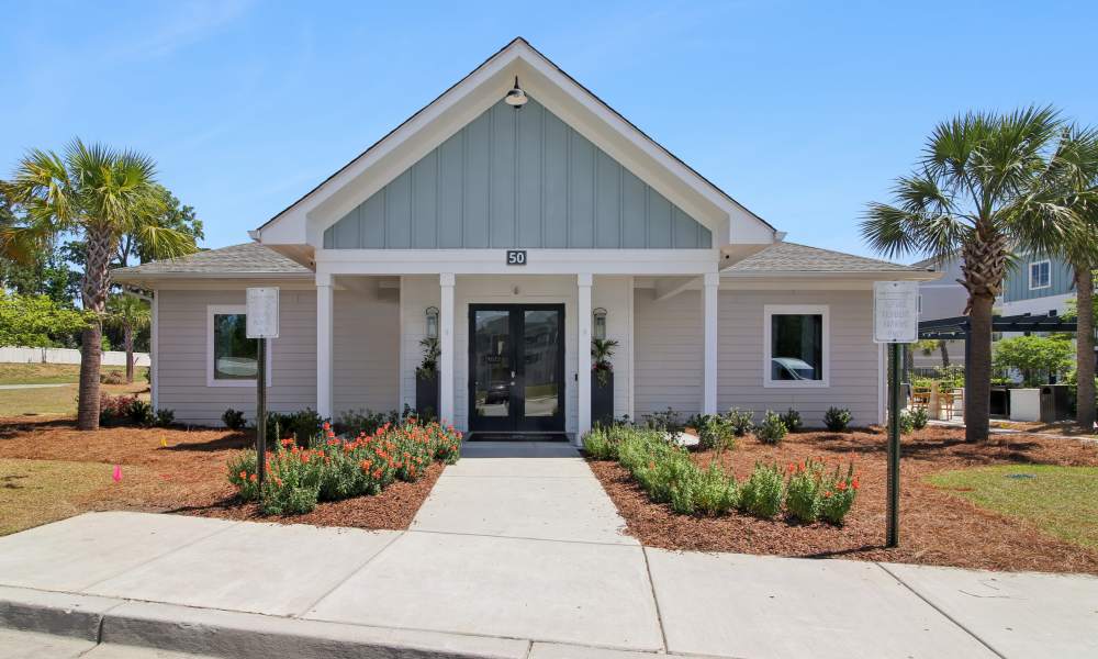 Charming apartment community entrance with landscaped gardens and palm trees at Everett at Port Wentworth in Port Wentworth, Georgia