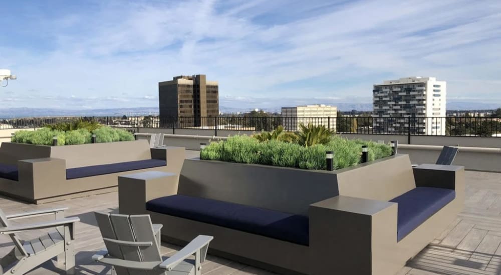 Residents with sparklers at the rooftop lounge at twilight at Ryan Tower in San Mateo, California