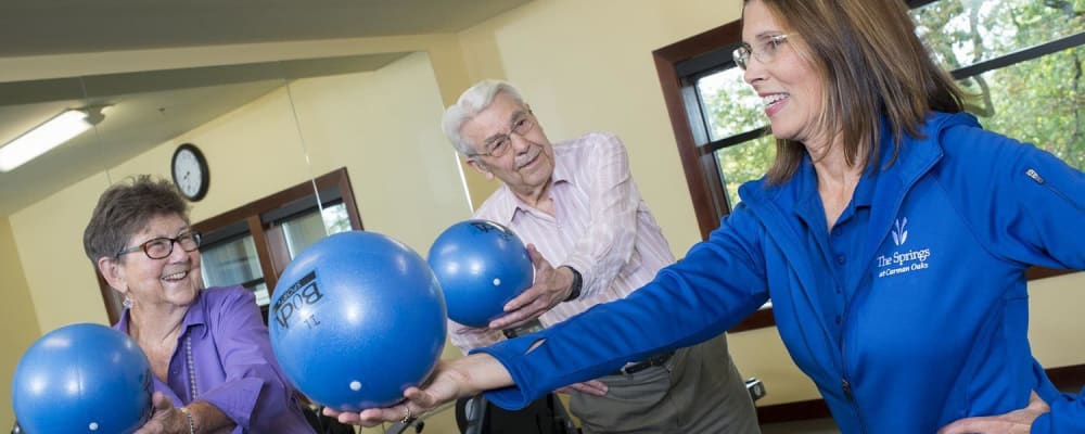 Residents working with fitness instructor at The Springs at Carman Oaks in Lake Oswego, Oregon