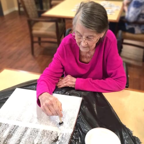 Resident painting at Oxford Glen Memory Care at Grand Prairie in Grand Prairie, Texas