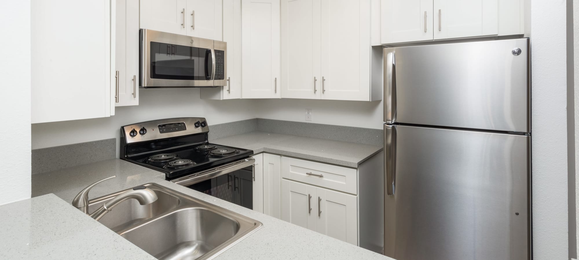 Kitchen with stainless-steel appliances at Los Feliz Village in Los Angeles, California