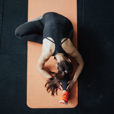 Resident doing yoga in fitness center at La Maison Of Saraland in Saraland, Alabama