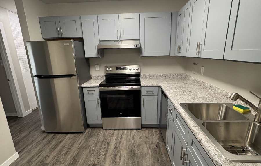 Modern kitchen with double sink at Broadway Crossing Apartments in Merrillville, Indiana