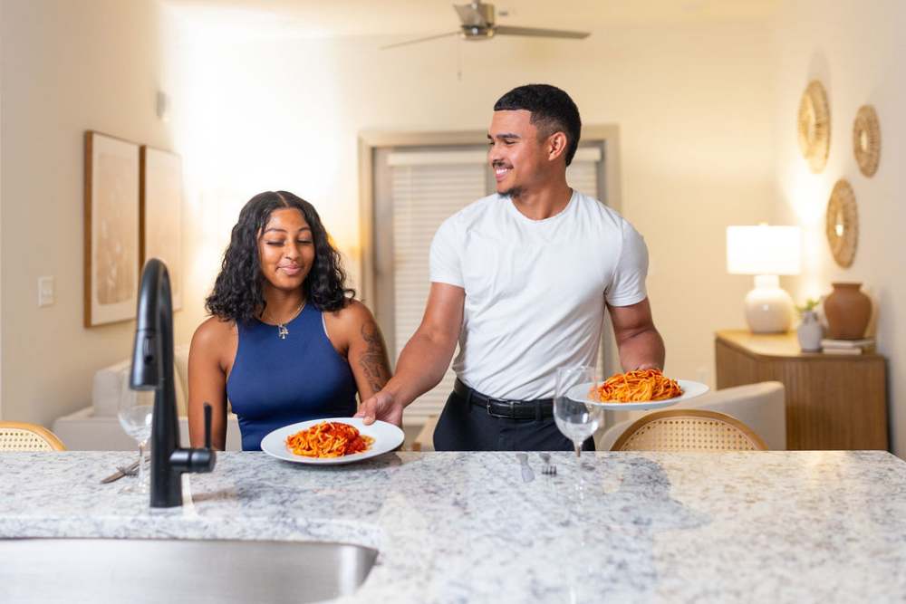 Residents enjoying food in their apartment at The Waters at Promenade in Marrero, Louisiana