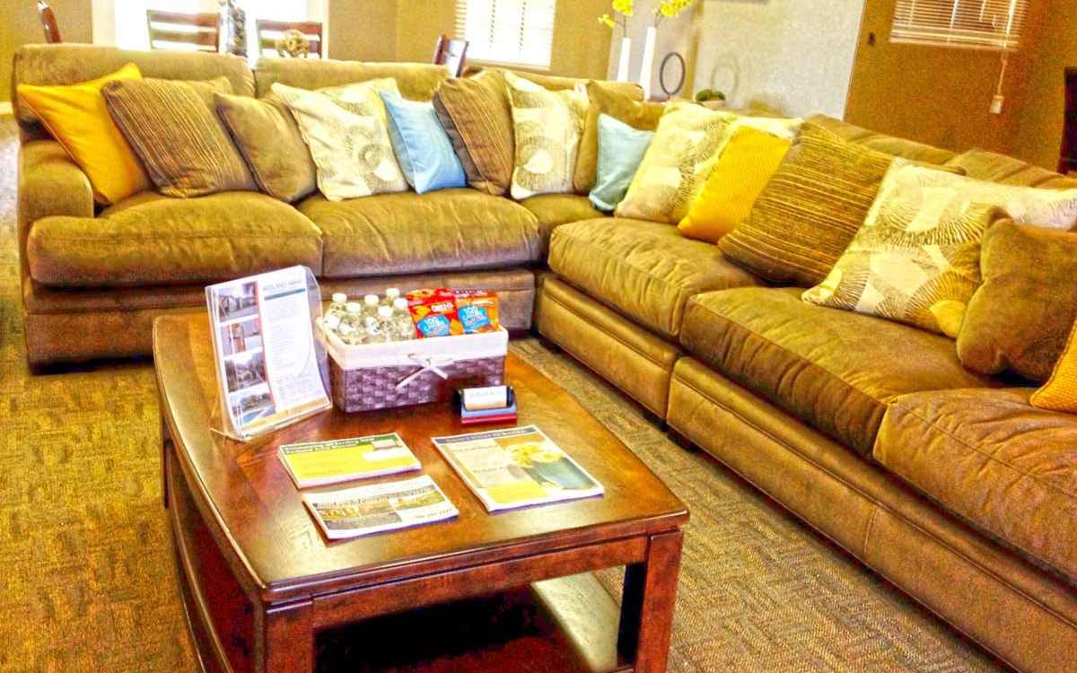 Cozy living room with a large couch and table at Redland Arms Apartments in Florida City, Florida