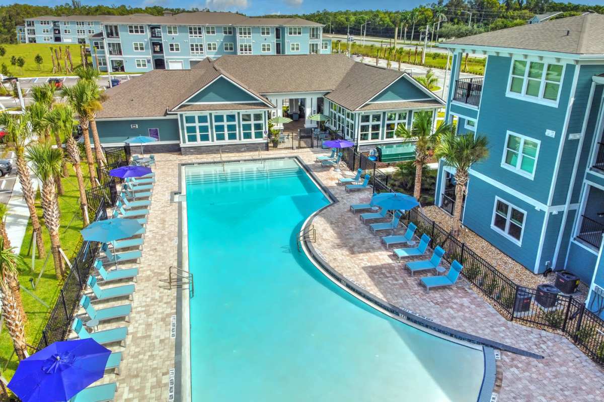 Drone view of the community with swimming pool at Lumen Luxury Apartments in Fort Myers, Florida