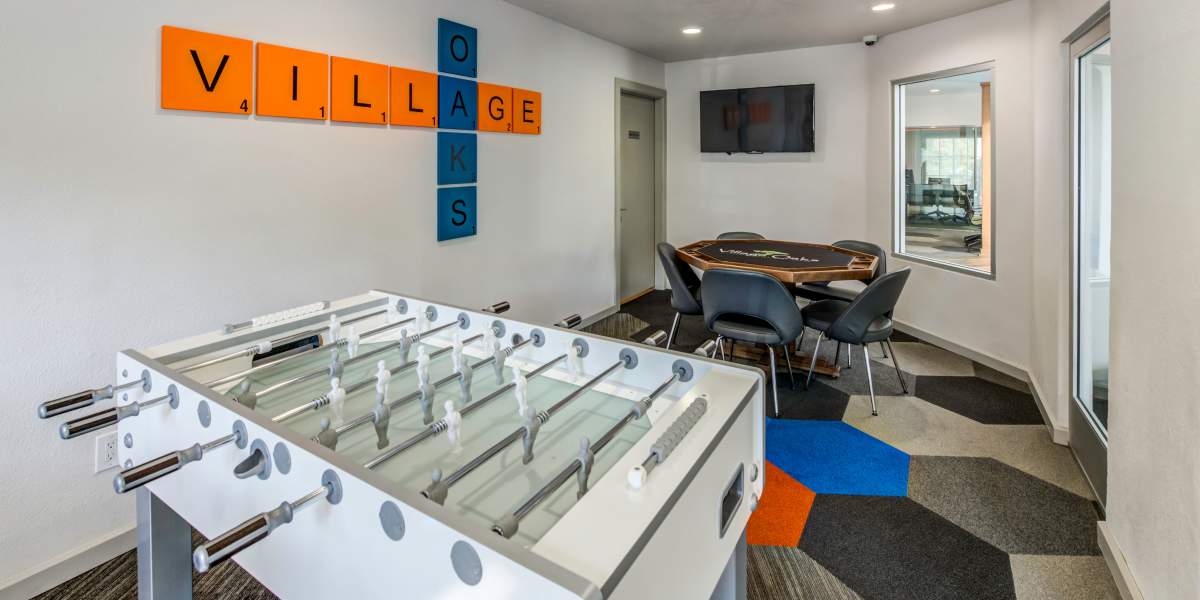 Game room with Foosball and a poker table at Village Oaks in Chino Hills, California