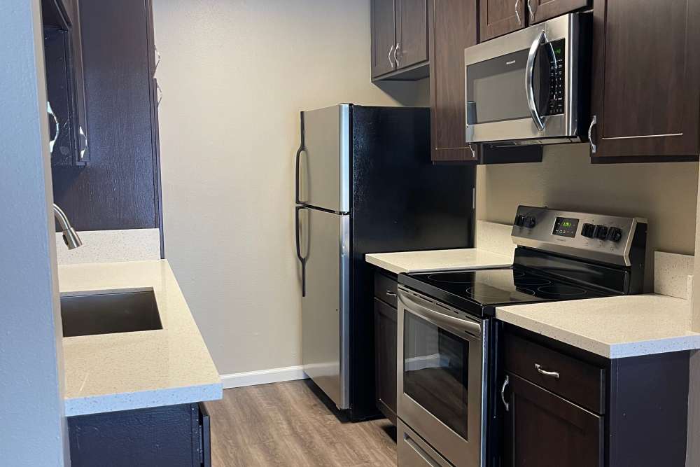 Modern kitchen with stainless-steel appliances at  Waterstone in Chatsworth, California