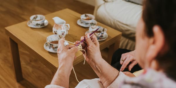 Resident knitting and having tea at Ingleside Communities in Mount Horeb, Wisconsin