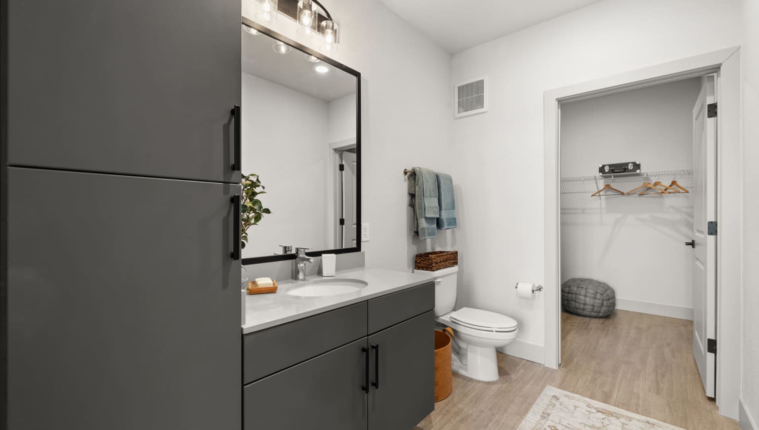 Bathroom with bathtub, vanity and wood-style flooring at The Lock at Flatirons in Broomfield, Colorado