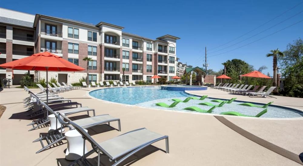 Serene swimming pool with a sundeck at Imperial Lofts in Sugar Land, Texas