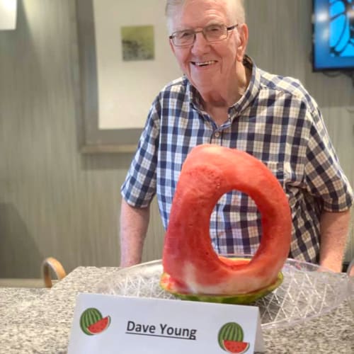 Resident displaying carved watermelon art at Oxford Villa Active Senior Apartments in Wichita, Kansas