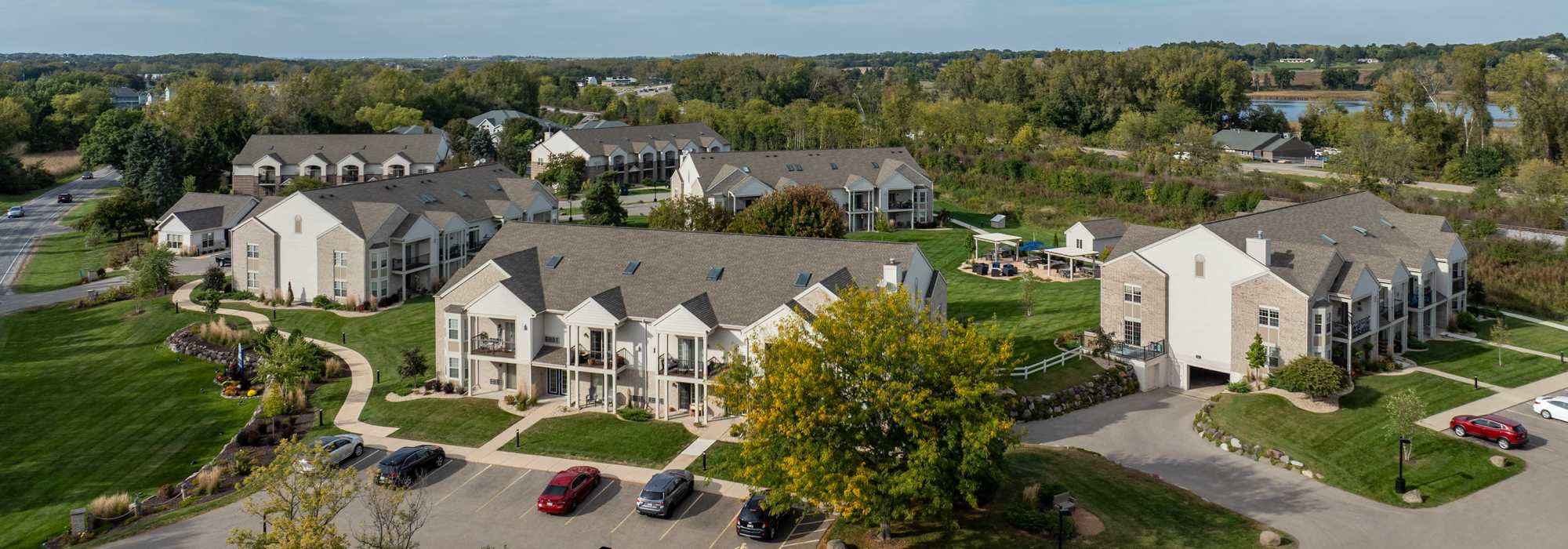 Charming community living at picturesque riverside location with lush landscaping, modern architecture, and inviting outdoor spaces at Lake Pointe Apartments in Madison, Wisconsin