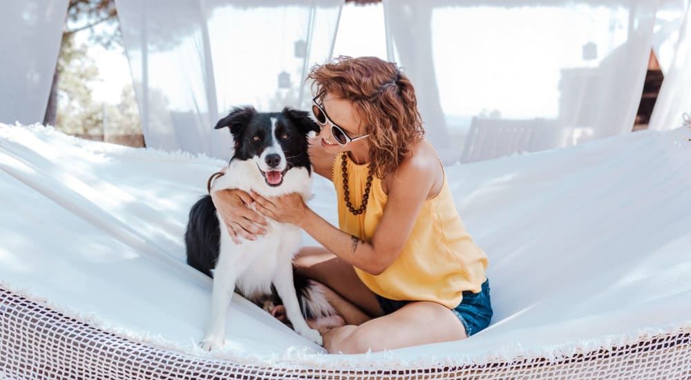 Woman hanging out with her border collie at Bellrock Sawyer Yards in Houston, Texas