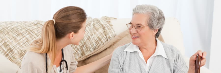 Resident sitting with her nurse at The Residences on Forest Lane in Montello, Wisconsin