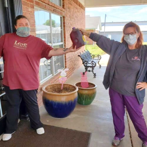 Masked caretakers socially distanced at Canoe Brook Assisted Living in Ardmore, Oklahoma