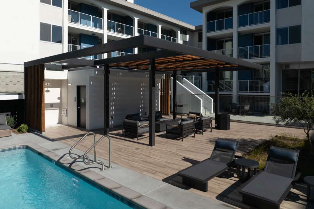 Loungers positioned by the pool with luxury at Dolphin Marina Apartments in Marina Del Rey, California