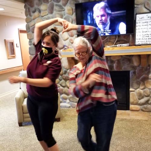 Resident dancing with a caretaker at The Oxford Grand Assisted Living & Memory Care in Wichita, Kansas