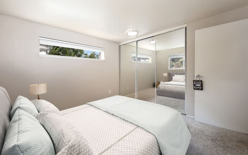 Spacious bedroom with plush carpeting at Latitude Apartments in Everett, Washington