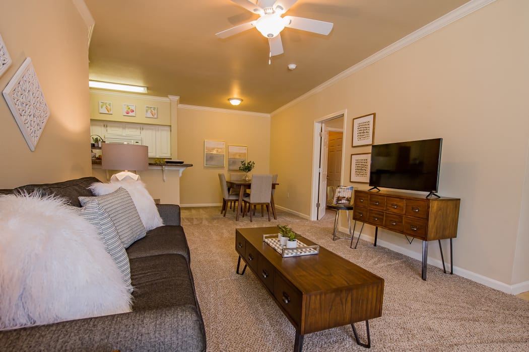Wonderful living room with ceiling fan at Lexington Park Apartment Homes in North Little Rock, Arkansas