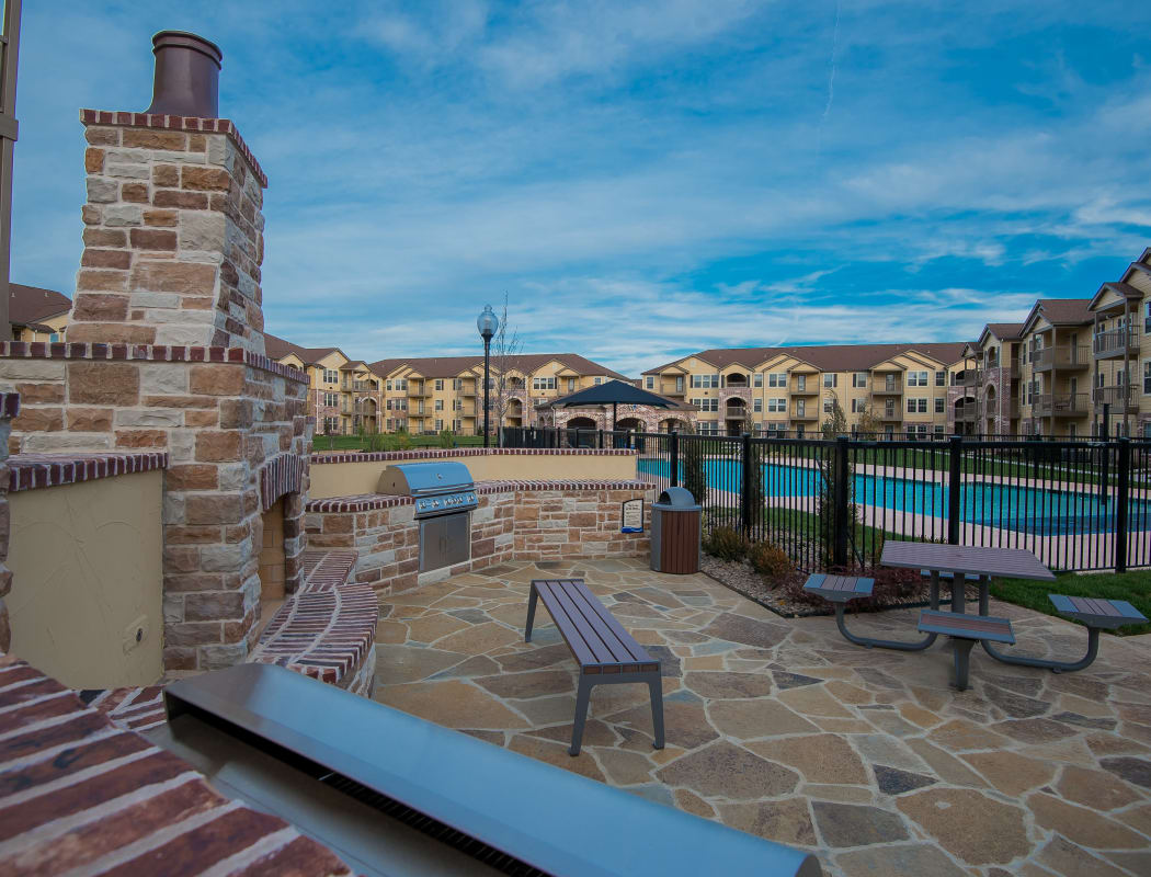 Outdoor patio by the pool at Portico at Friars Creek Apartments in Temple, Texas