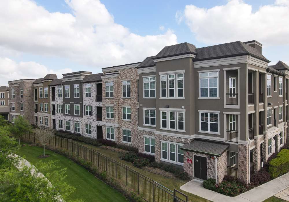 Exterior view of the community building with balcony view at Orleans at Fannin Station in Houston, Texas