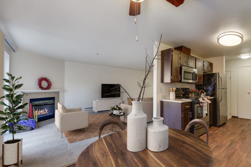 Dining room and kitchen with wood-style flooring looking over the living room in an apartment at Renaissance at 29th Apartments in Vancouver, Washington