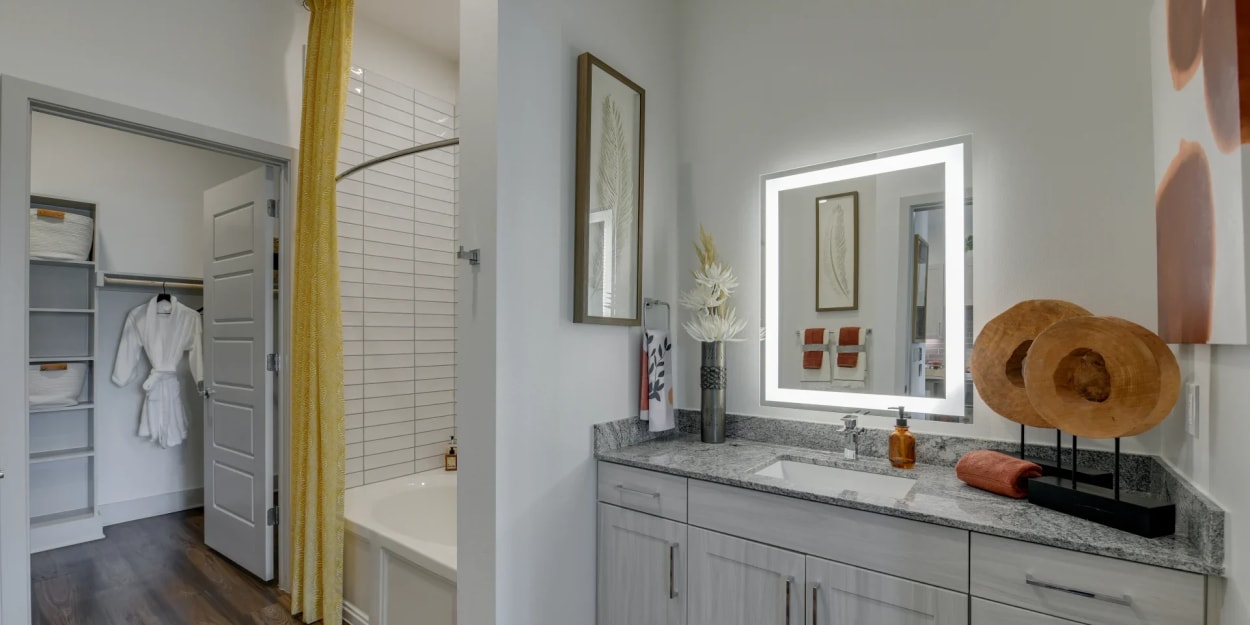 Bathroom with backlit mirror at Luxia Midtown Park, Dallas, Texas