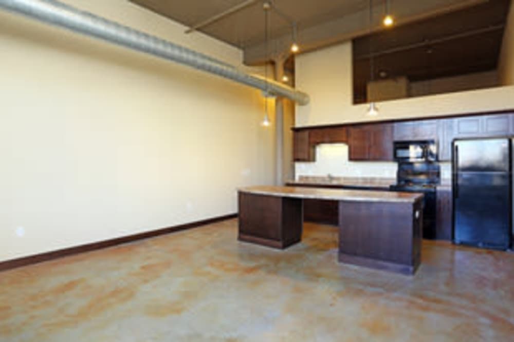 Open kitchen with island and appliances at Rumely Lofts in Des Moines, Iowa