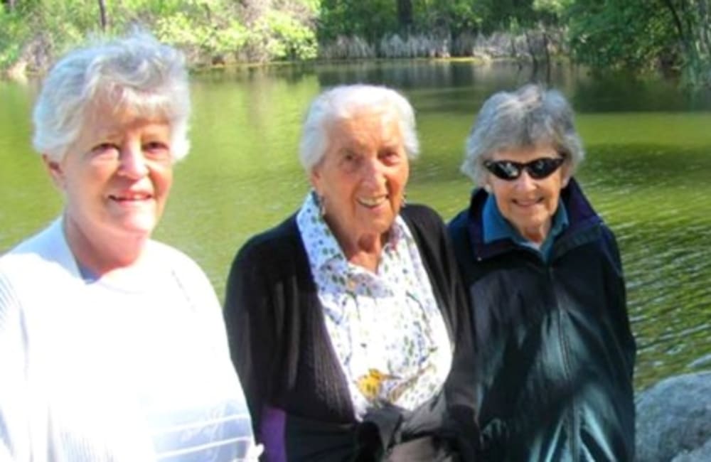 Residents enjoying an day out by a nice pond near Hilltop Commons Senior Living in Grass Valley, California