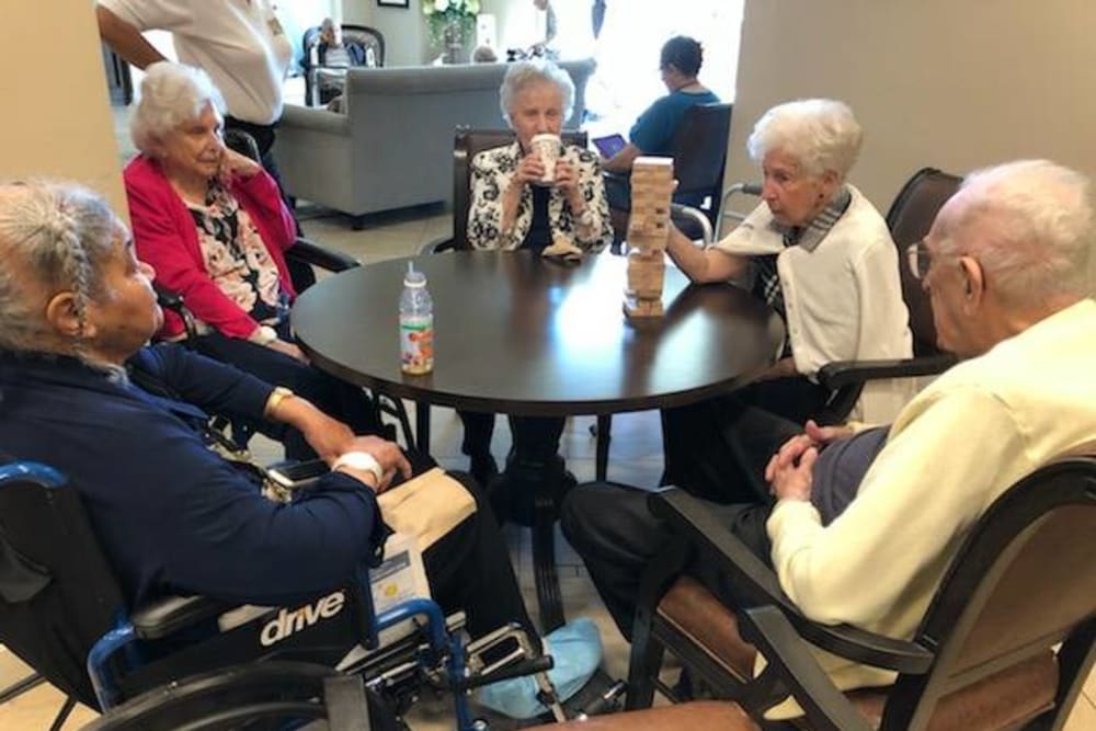 Residents playing Jenga at Inspired Living Kenner in Kenner, Louisiana